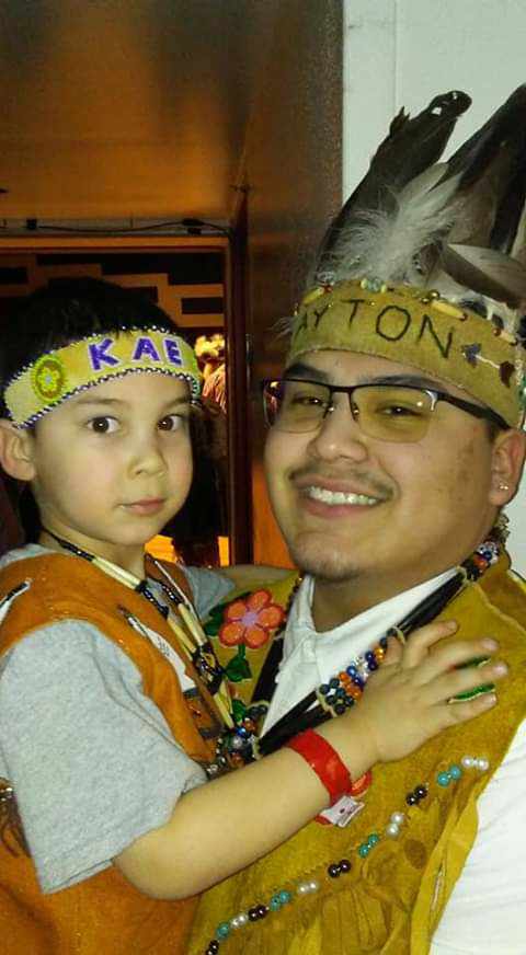 photo of man and son in tribal regalia