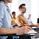 woman taking notes in classroom