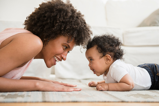 woman and baby smiling at each other