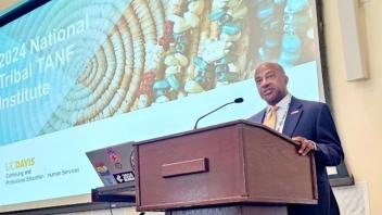 Chancellor giving a speech at a podium