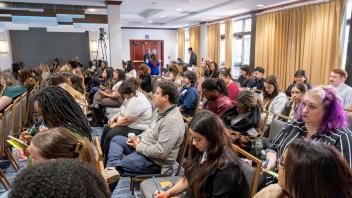 Crowded conference room, attentive diverse audience facing speaker (photo)