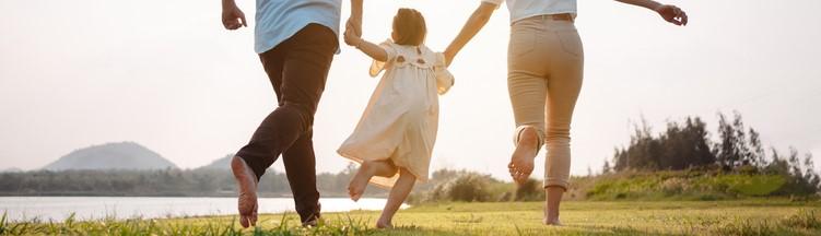 Parents holding child's hand