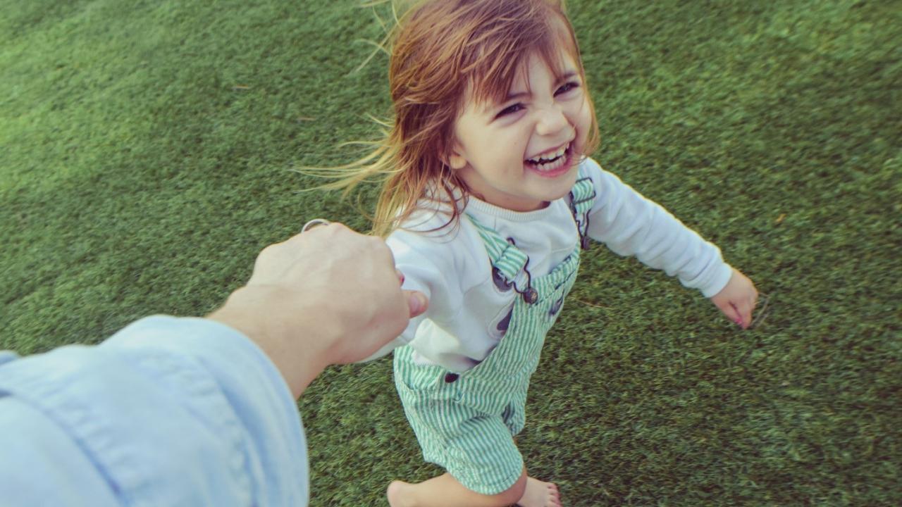 girl holding dad's hand