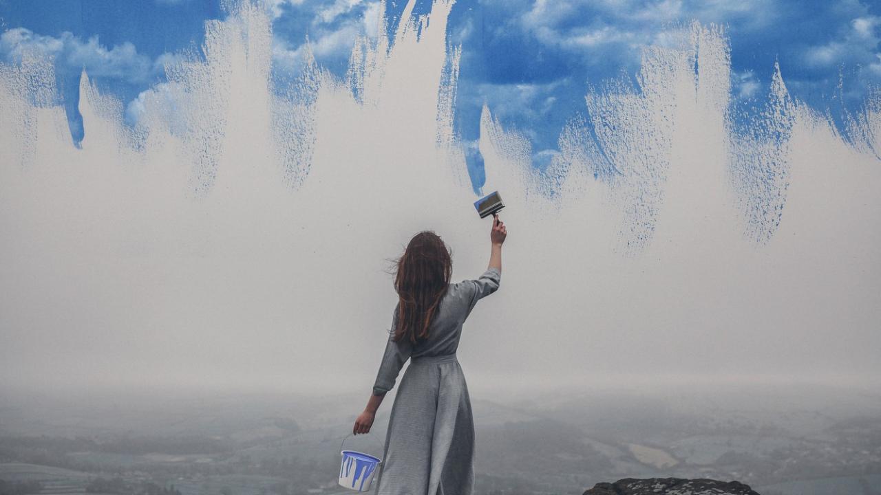 woman painting the sky