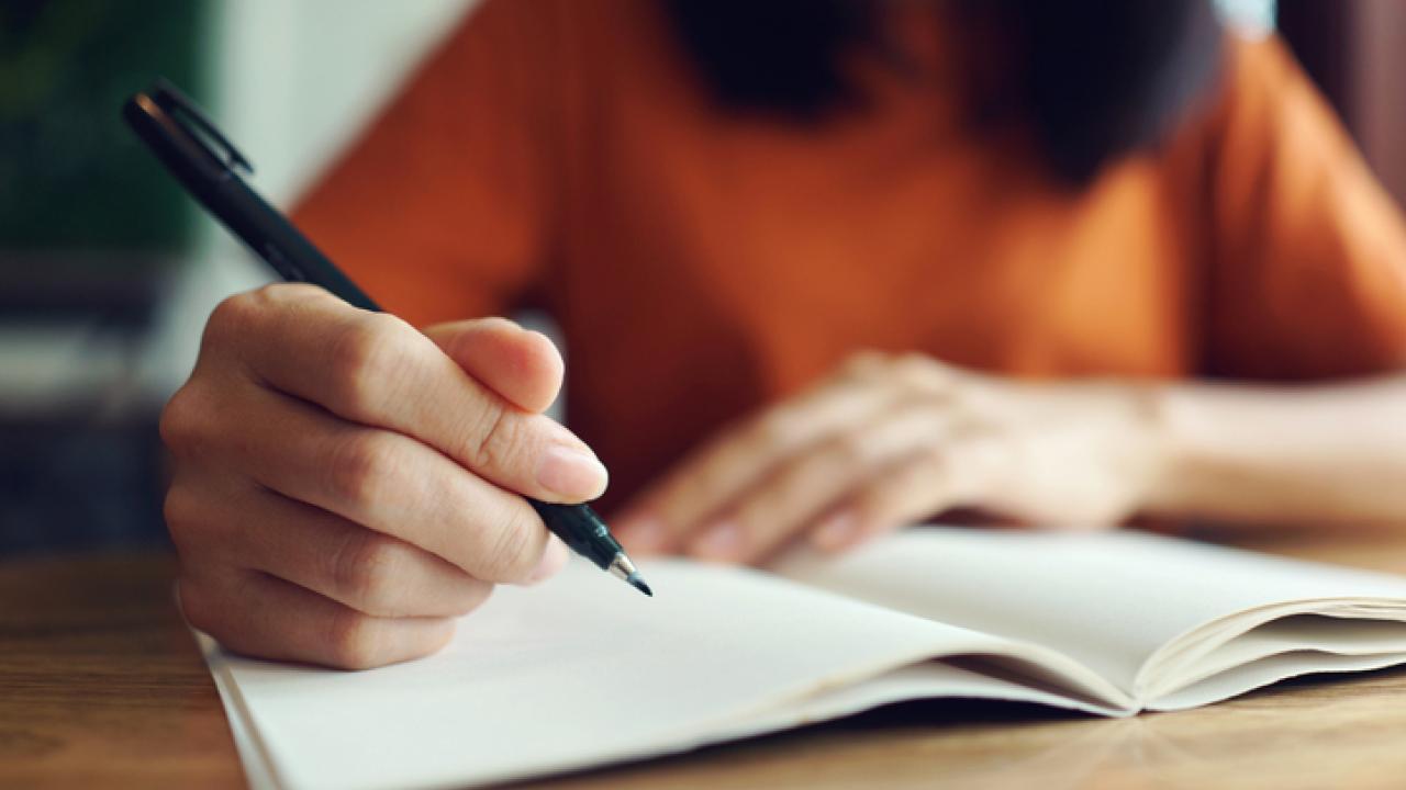 Person writing in notebook
