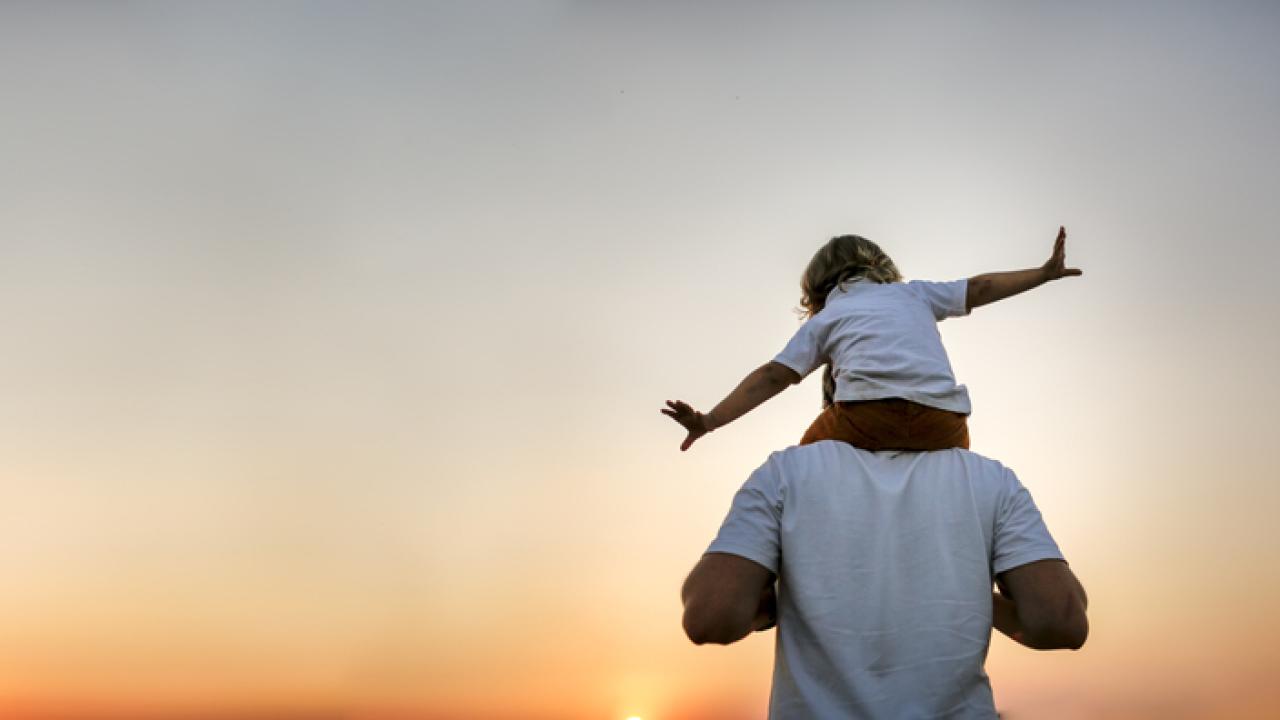 Man with happy child on his shoulders