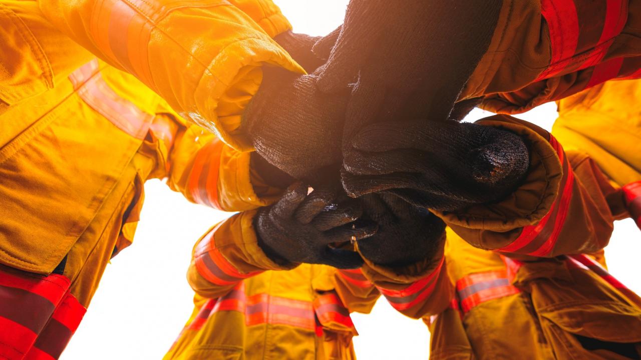 Photo of firefighters holding hands