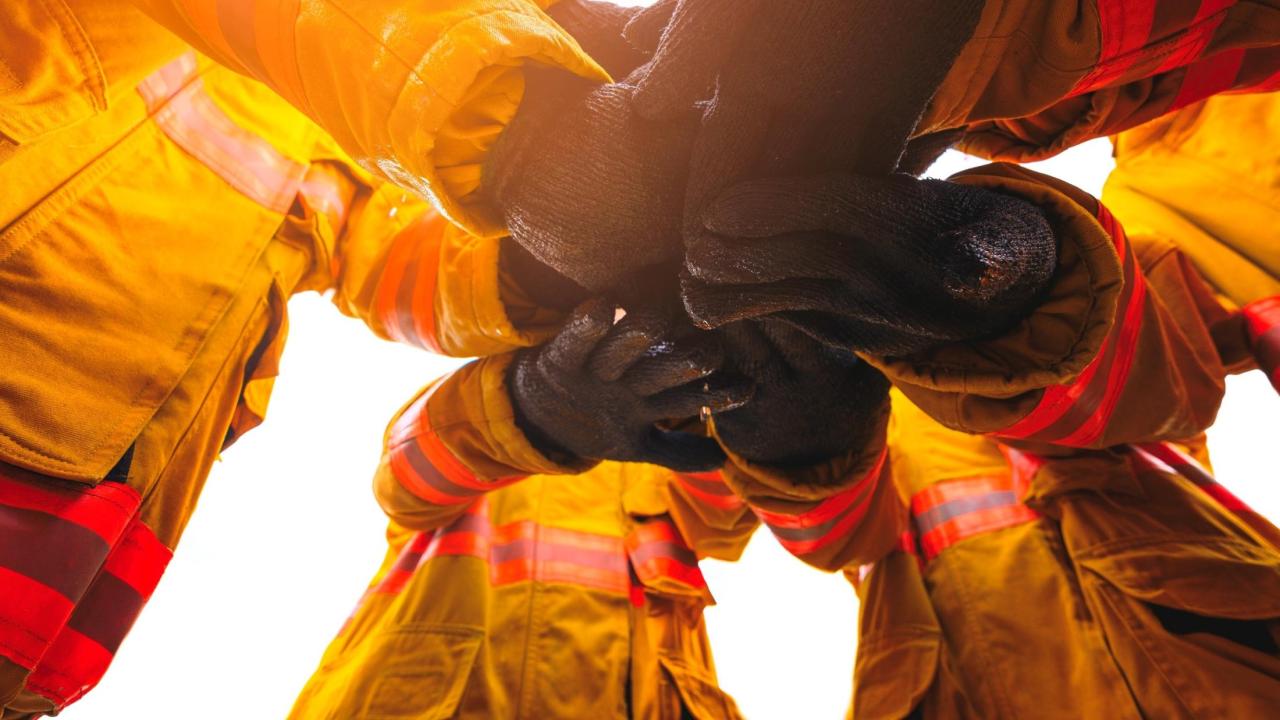 Photo of firefighters holding hands