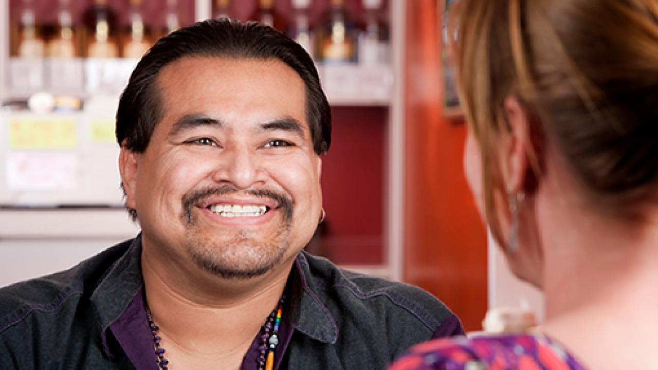 man smiling at woman not facing camera