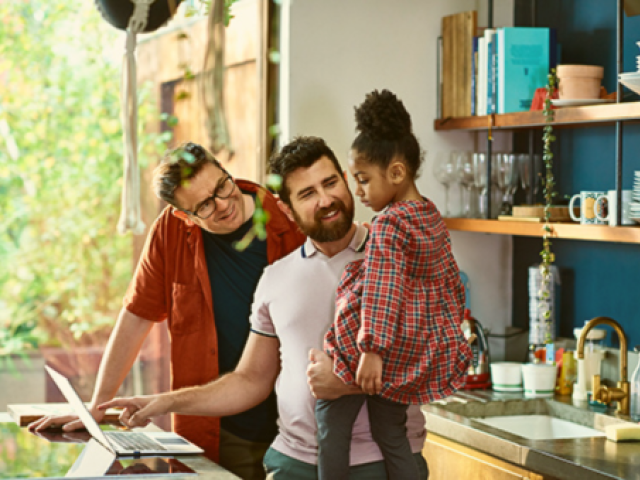 Two adults and a smiling child