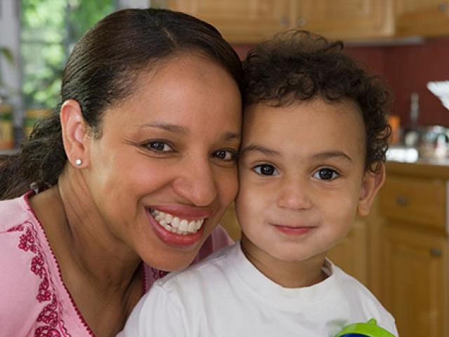 A woman and child smiling.