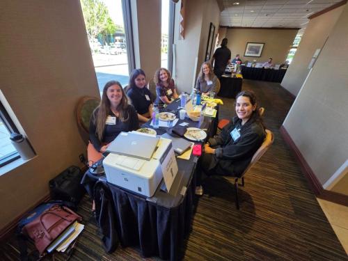 Friendly Academy staff at CQI Conference registration table