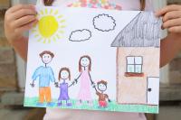 Child's drawing of a family outside the home on a partially cloudy day.