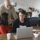 son at laptop with family