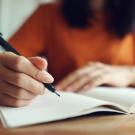 Person writing in notebook