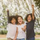 Three girls cheering in triumph
