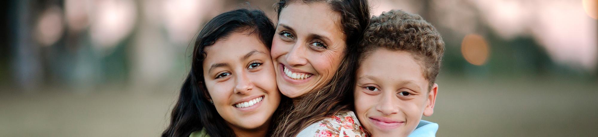 woman and two children hugging