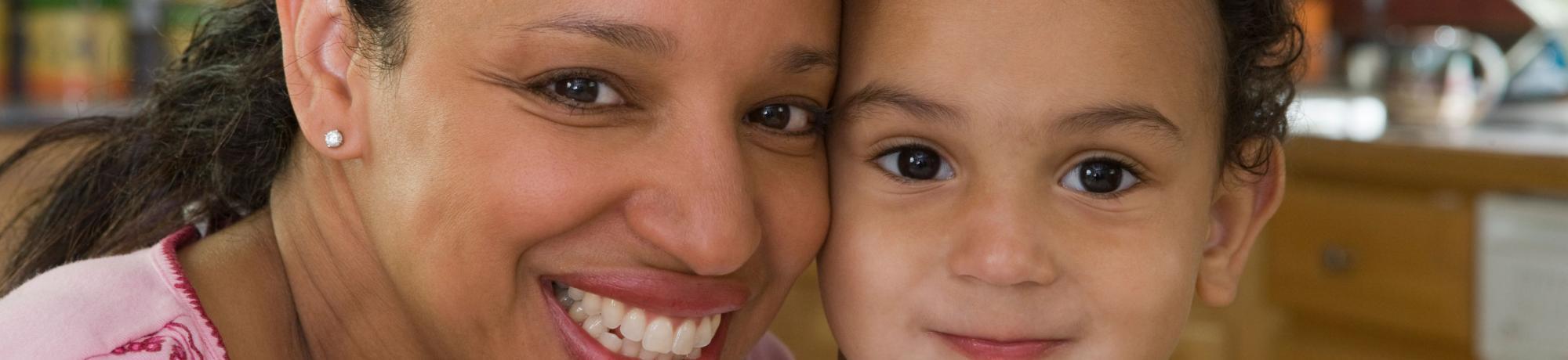 A woman and child smiling.